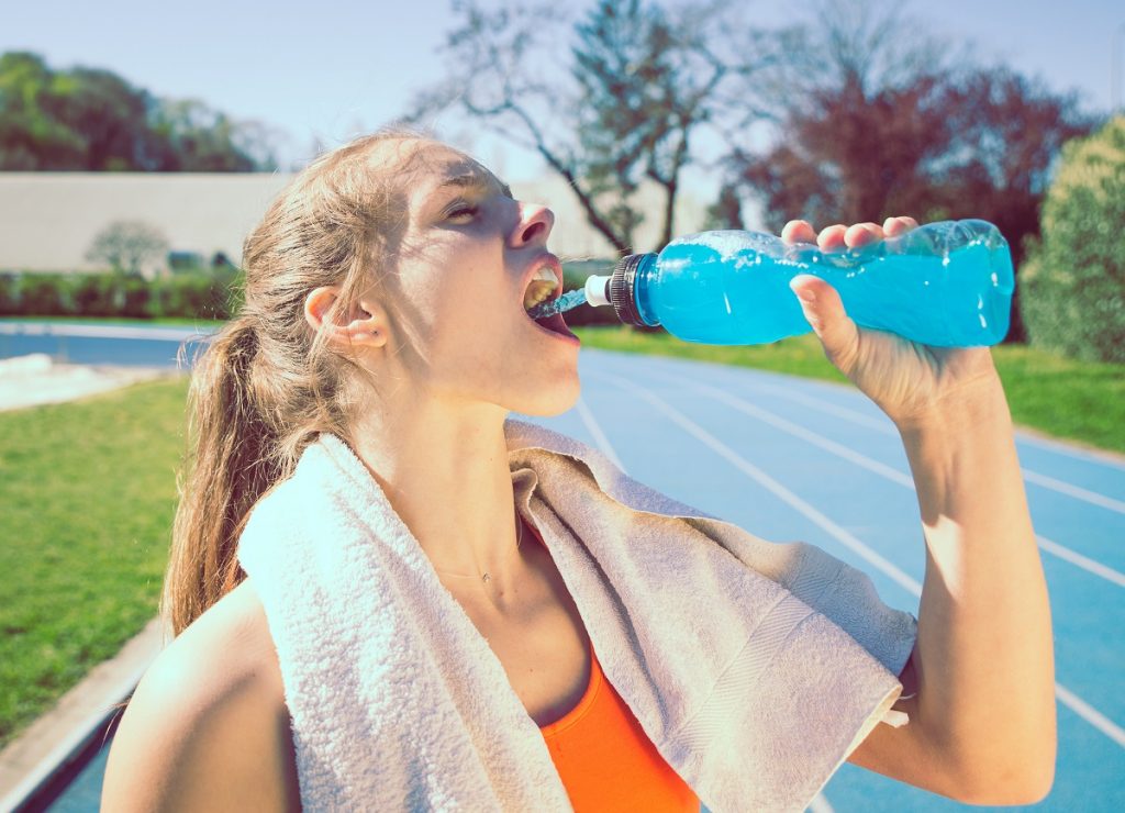 Woman having a sports drink after a run