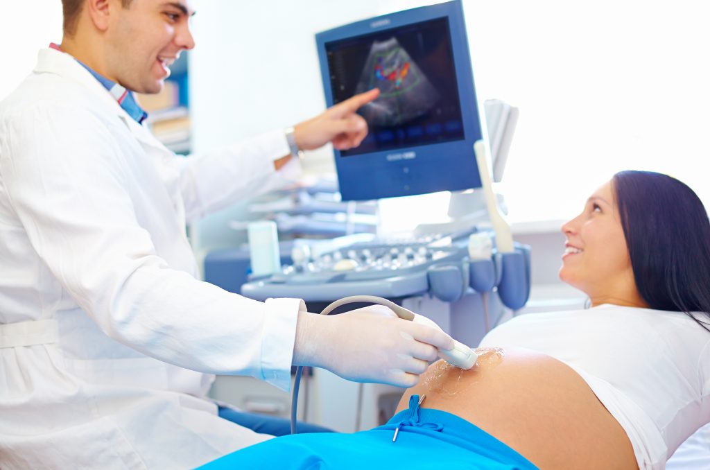 Pregnant woman having her routine checkup and ultrasound