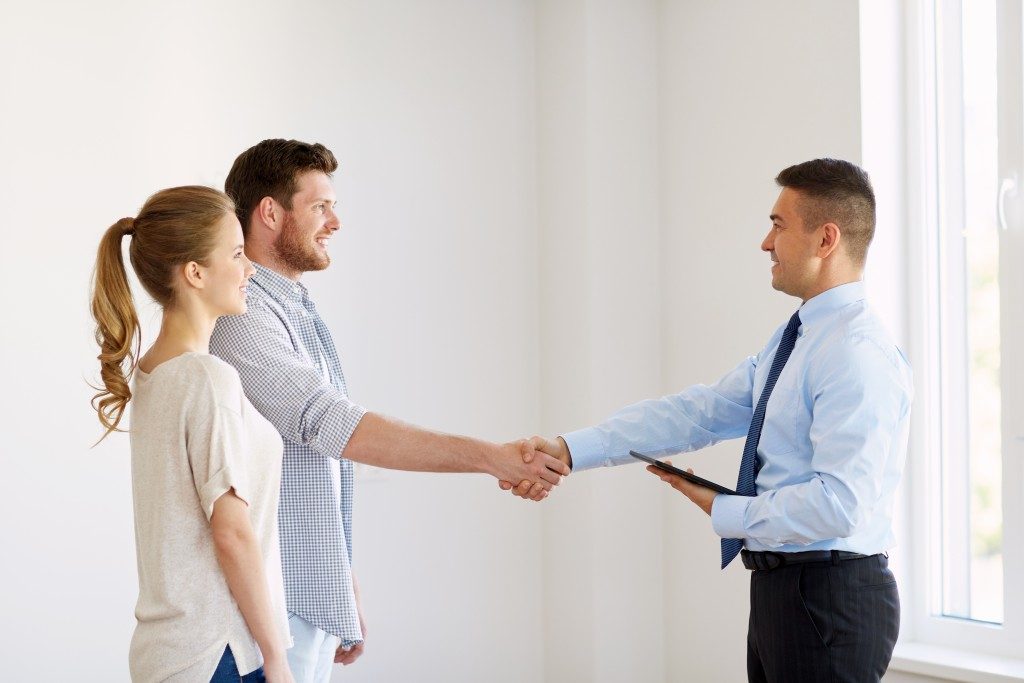 realtor shaking hands with a man