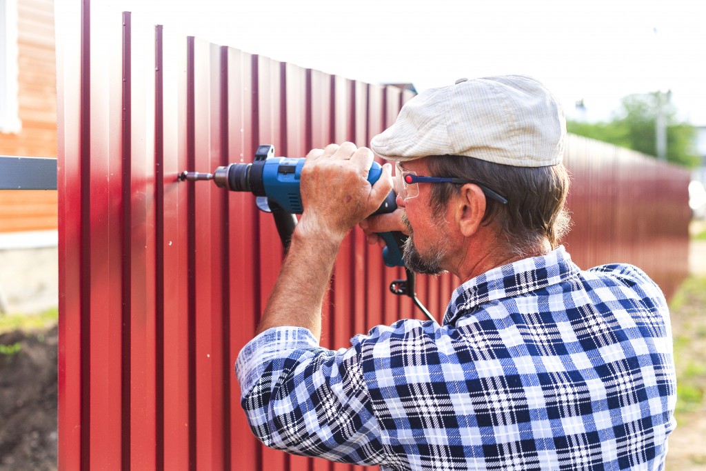 man installing fence