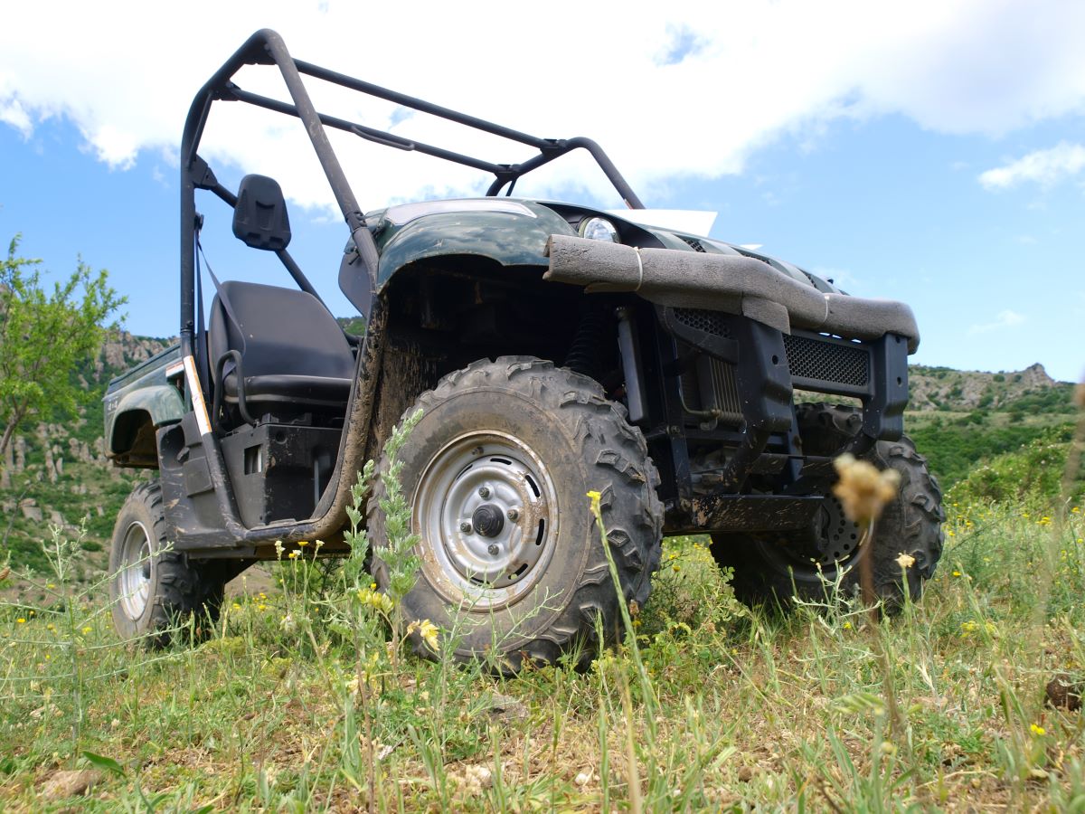 Moto all-terrain vehicle in mountains against blue sky