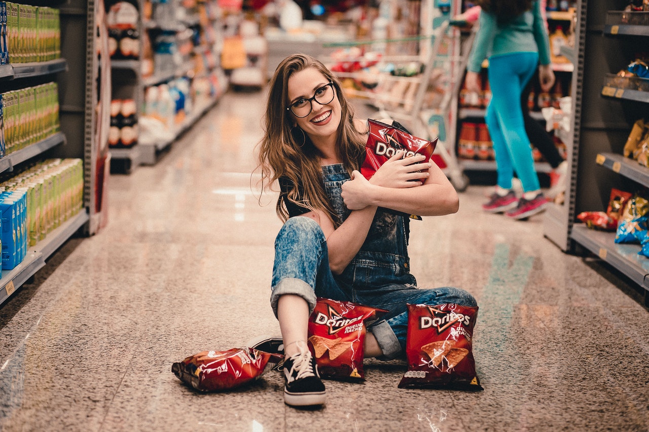 woman holding bags of chips