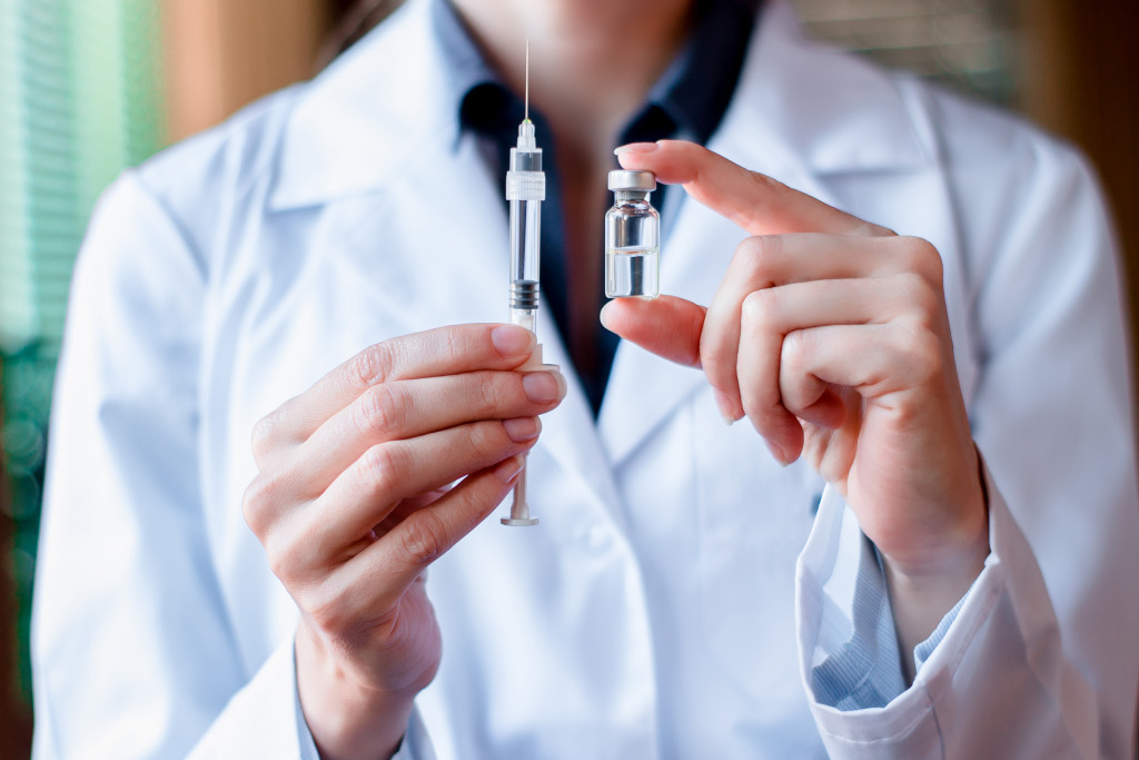 doctor holding syringe and vial