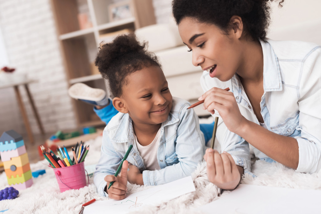 child and parent making art project