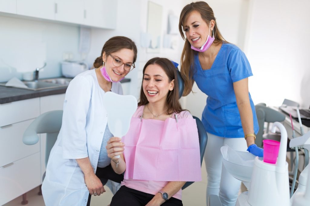 woman smiling with dentists