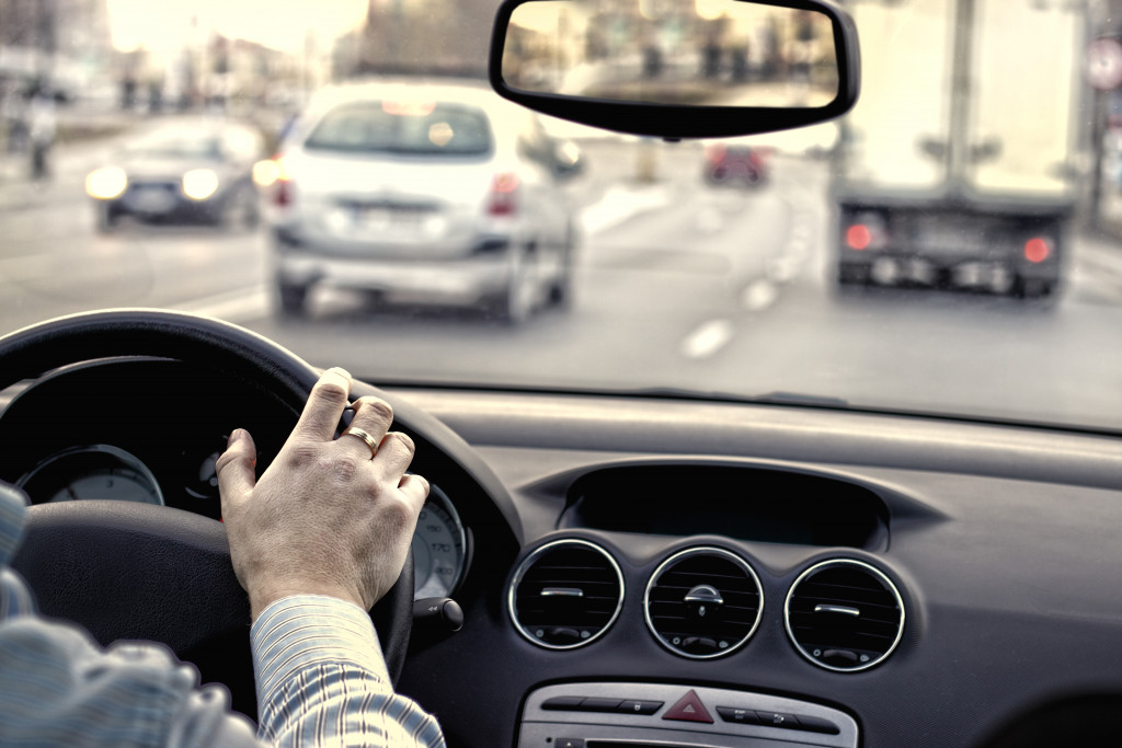 Person driving in the city with light traffic.