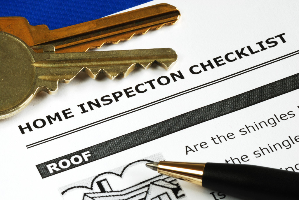 Checklist of home inspection with keys and pen