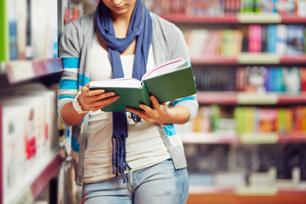 Woman reads a book in the library