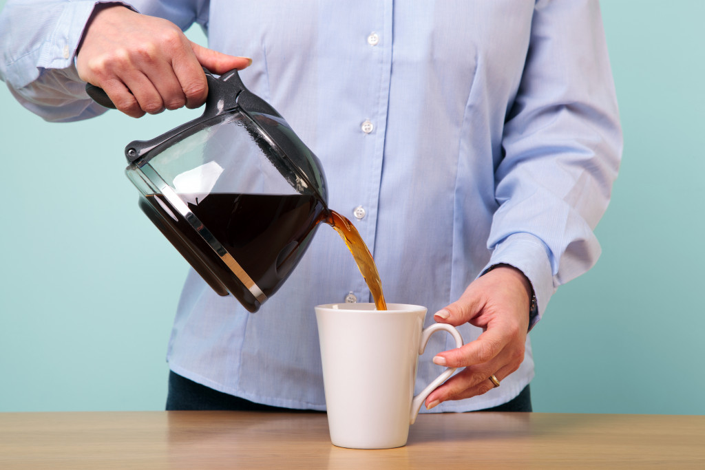 Someone pouring a cup of coffee