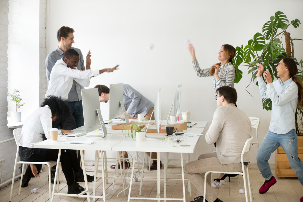 a group of employees playing in the table