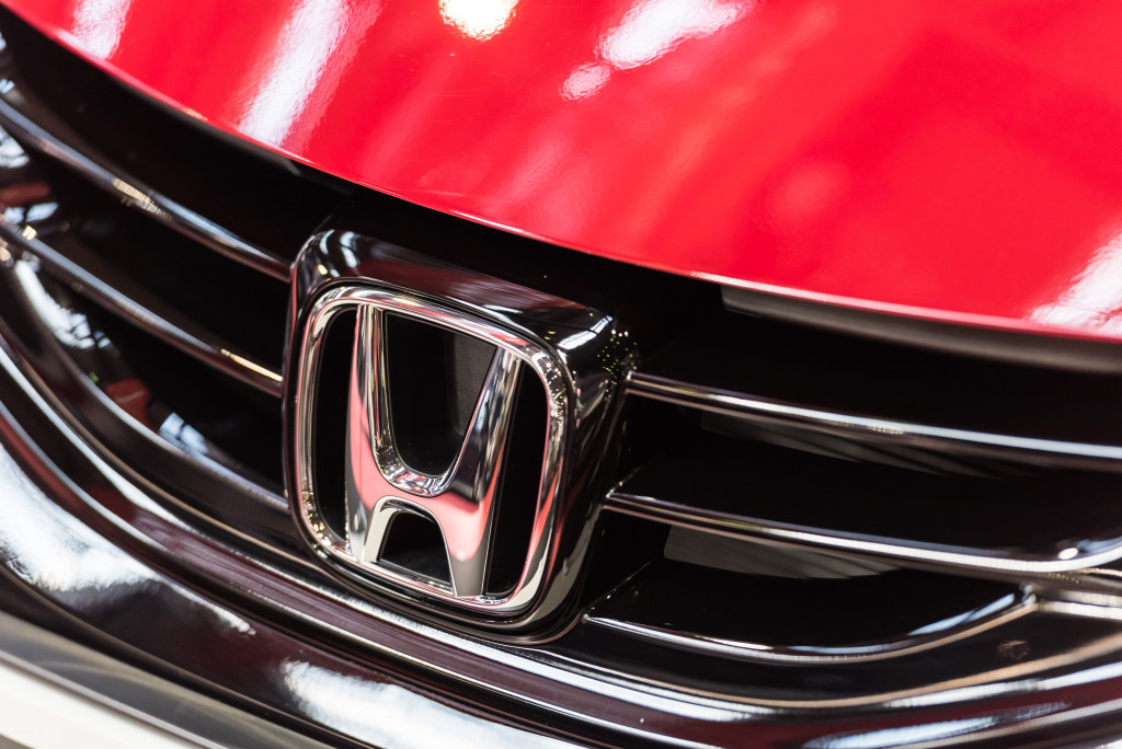 Closeup of a Honda logo on red car