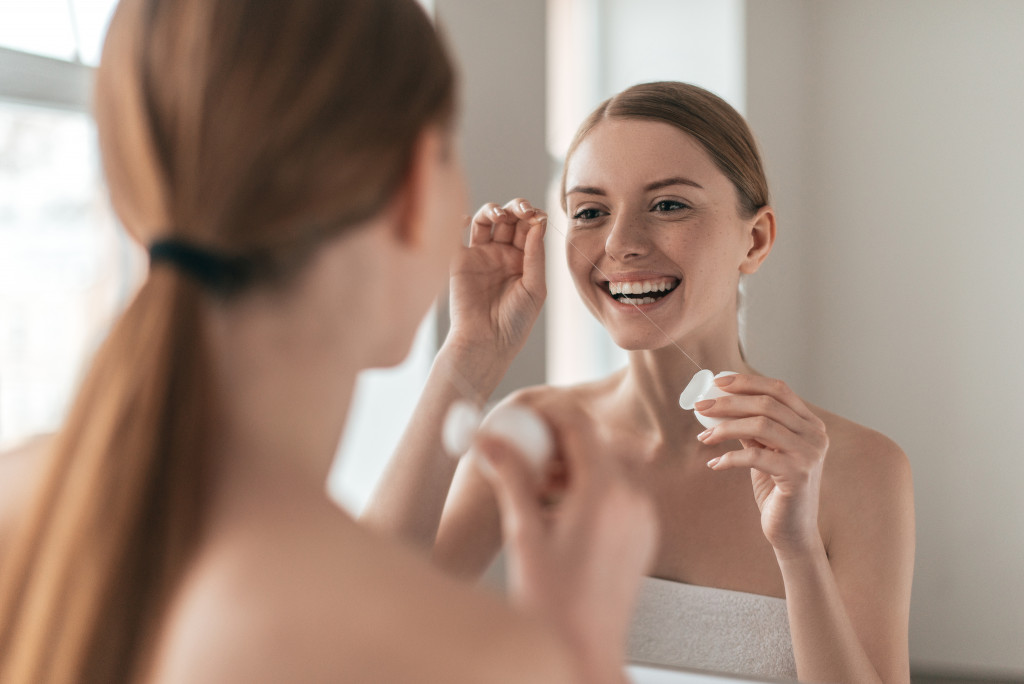 a woman looking at herself in the mirror smiling