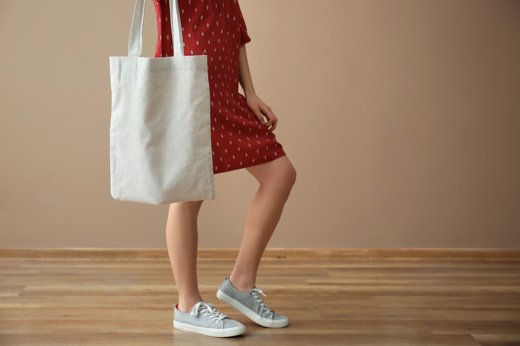 A woman using a tote bag for shopping