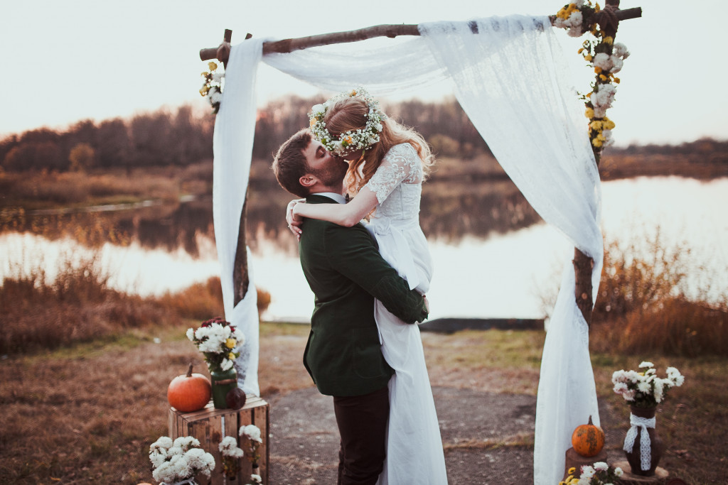 bride and couple kissing with a rustic and beautiful view