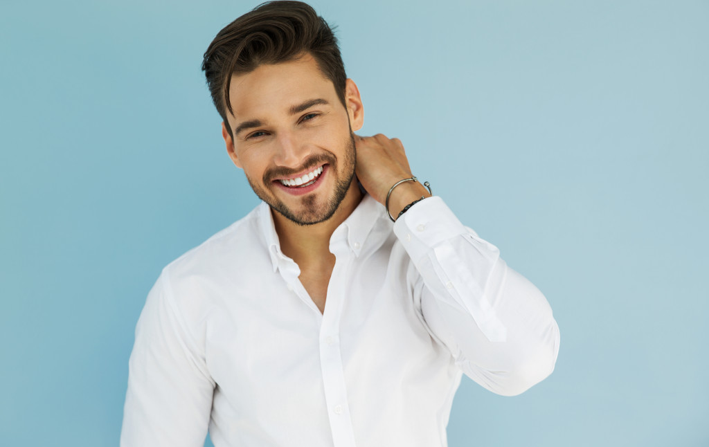 A man wearing a white long-sleeved polo shirt