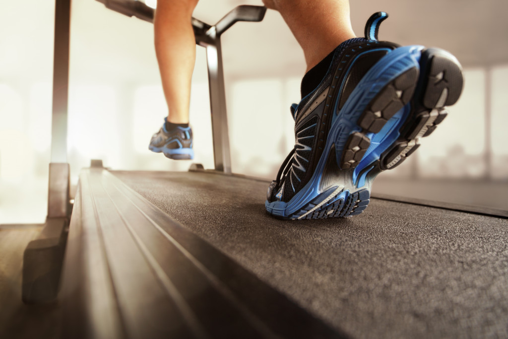 A man wearing stylish running shoes on a treadmill