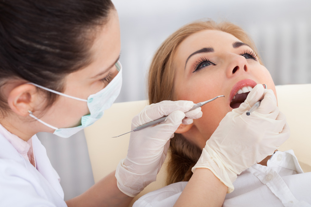 dentist performing a dental check up on her patient