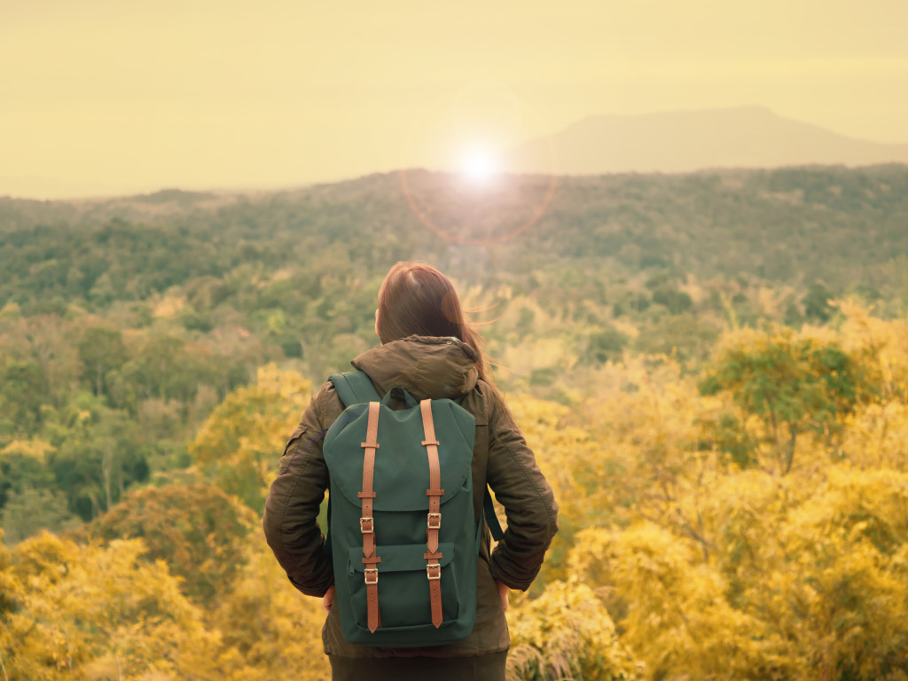 woman in warm cloth with her bag travel, relax