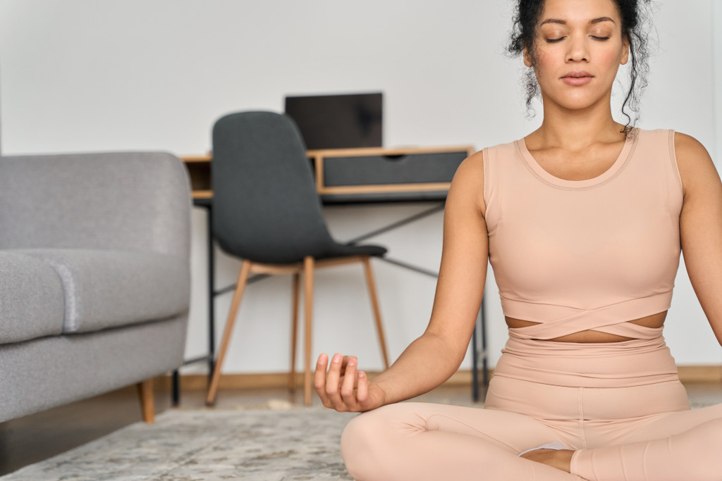 Young woman practicing yoga at home.