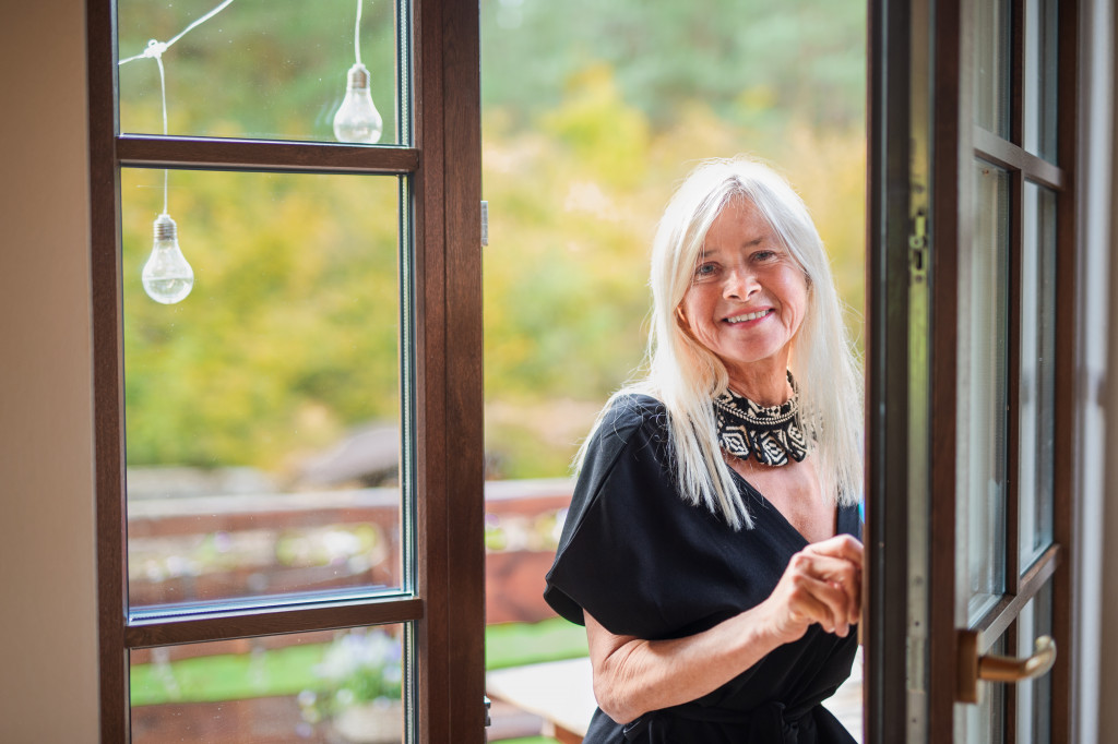 smiling woman entering her house