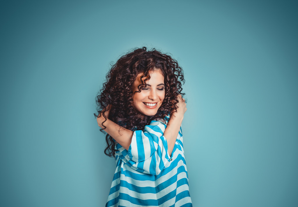 woman hugging herself concept of self care