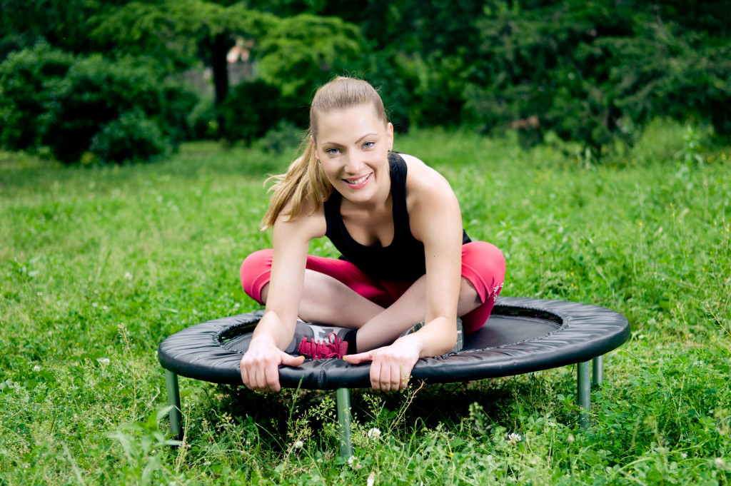 a woman exercising using trampoline